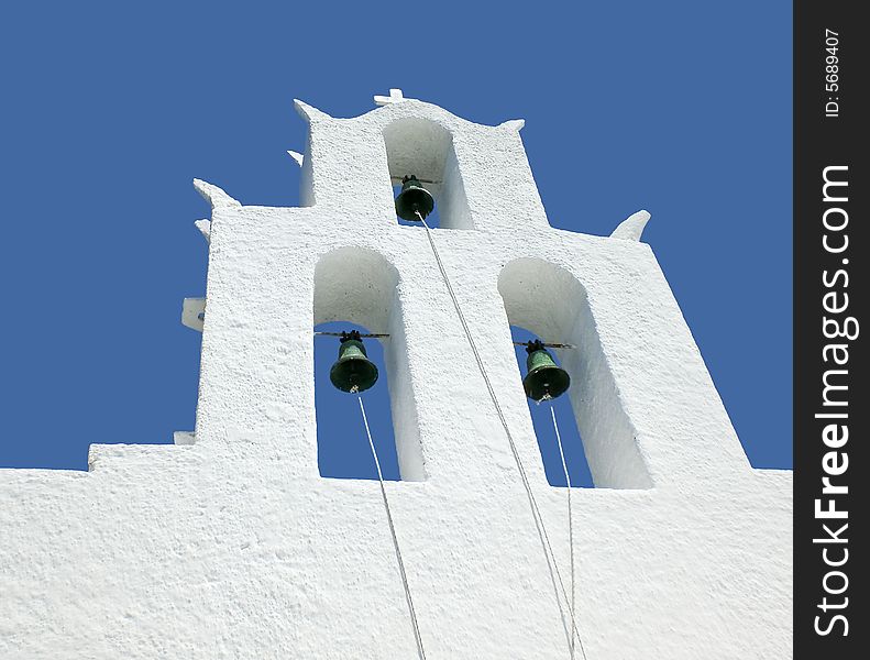 White bell tower of a church in Greece. White bell tower of a church in Greece.