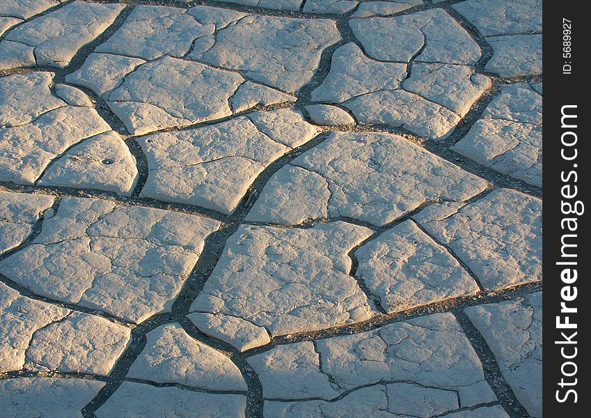 Sand filled cracks in sun baked clay beneath the dunes in Death Valley Nat'l Park. Sand filled cracks in sun baked clay beneath the dunes in Death Valley Nat'l Park