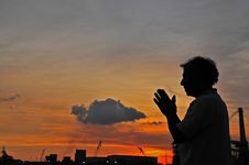 Sunset, Cloud And Prayer At The Seaside Stock Photo