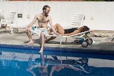 Man And Woman Lounging Beside A Pool - Horizontal Royalty Free Stock Photos Man And Woman Lounging Beside A Pool - Horizontal Royalty Free Stock Photos