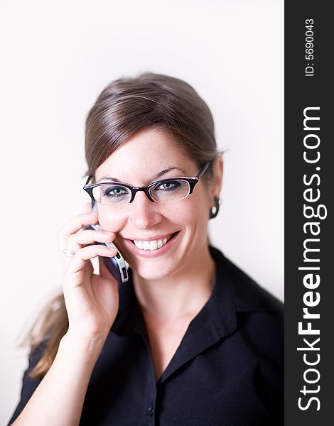 Young woman holds her opposite hear as she talks on a cell phone. It looks as if she is stressed or in concentration. She is very modern and well dressed. Young woman holds her opposite hear as she talks on a cell phone. It looks as if she is stressed or in concentration. She is very modern and well dressed.