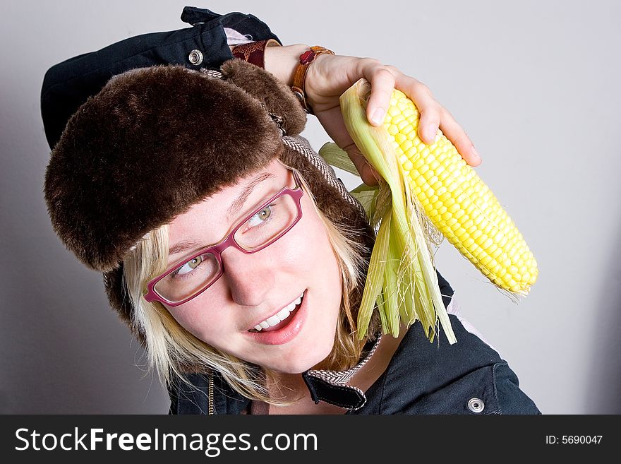 Young Woman Staring At Cob Of Corn.