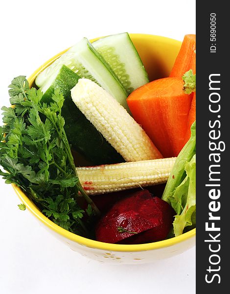 Bowl of fresh vegetables isolated on white.