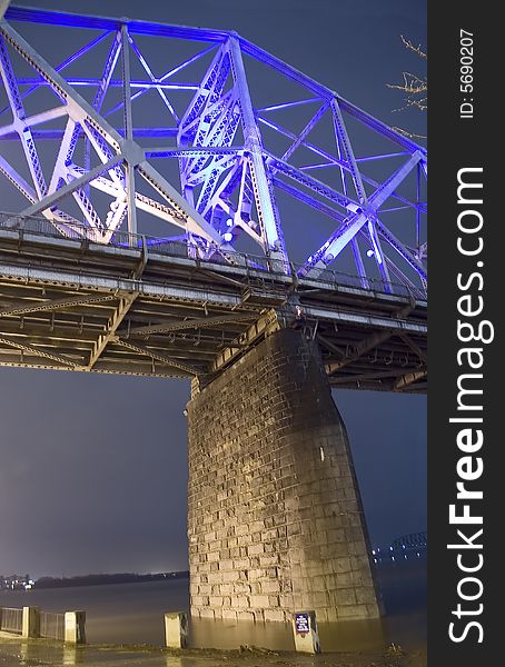 A night time view of the underside of a bridge. A night time view of the underside of a bridge