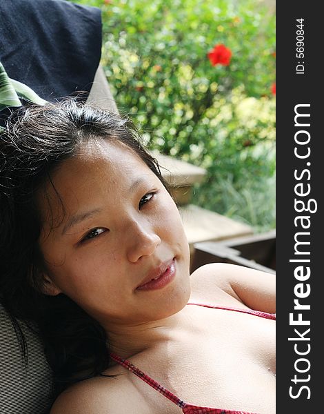 Portrait of a pretty Korean woman at a tropical resort. Portrait of a pretty Korean woman at a tropical resort.