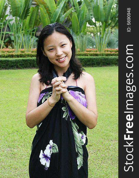 Asian woman in a pretty summer sarong.