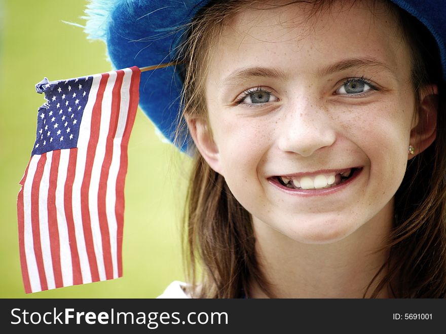 Young girl wearing blue hat with flag. Young girl wearing blue hat with flag