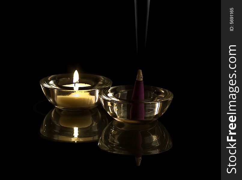 Incense in candlelight with black background. Incense in candlelight with black background