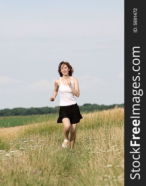 A beautiful girl running on the field