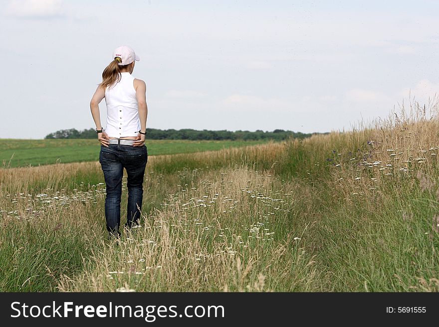 A nice girl walking on the field