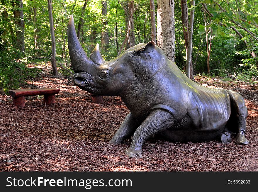 A metal rhinoceros in a public park