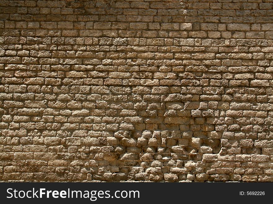 Background or pattern of a broken brick stone wall, historic european church. Background or pattern of a broken brick stone wall, historic european church