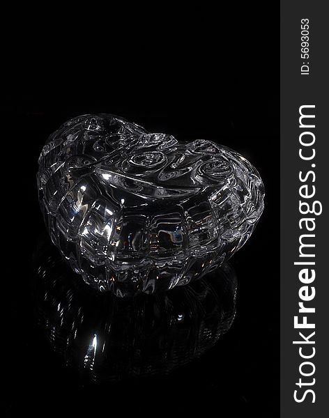 Glass casket for costume jewellery on a black background