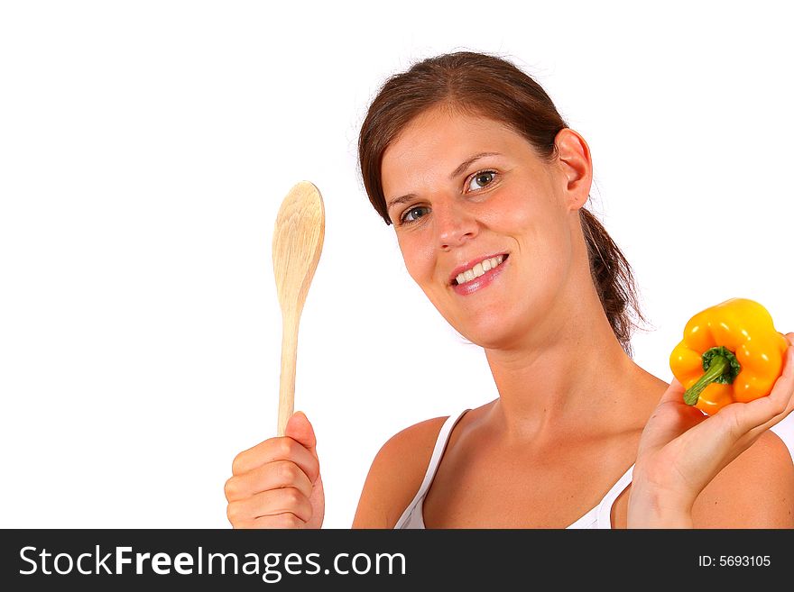 A young happy woman with vegetables and a spoon. Can be used as a cooking / diet shot. A young happy woman with vegetables and a spoon. Can be used as a cooking / diet shot.