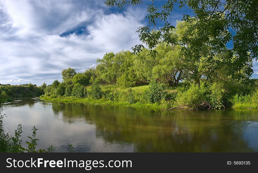 Summer landscape with river, trees, and blue sky with clouds. Summer landscape with river, trees, and blue sky with clouds