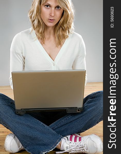 Pretty blond girl with laptop computer. Pretty blond girl with laptop computer