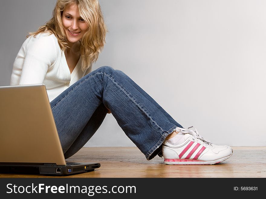 Pretty blond girl with laptop computer. Pretty blond girl with laptop computer