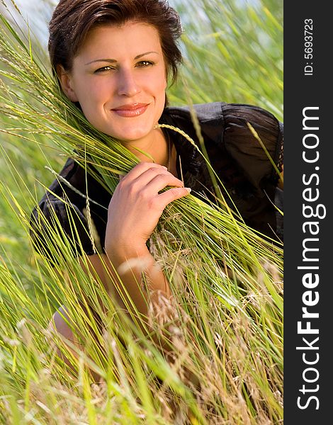 Young caucasian girl on green grass field