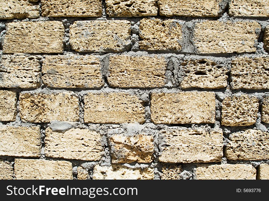 Wall from a rough yellow brick