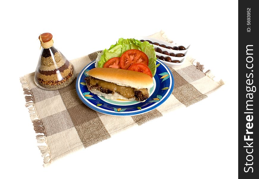 Hot Roast beef and gravy roll with lettuce, tomato and olives isolated over white background. Hot Roast beef and gravy roll with lettuce, tomato and olives isolated over white background.
