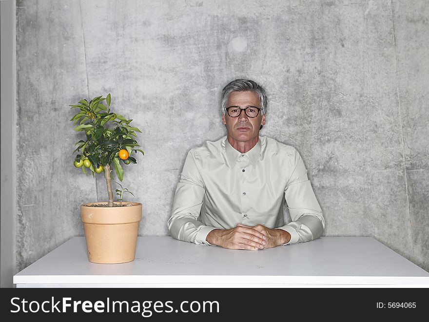 man with plant alone in the room. man with plant alone in the room