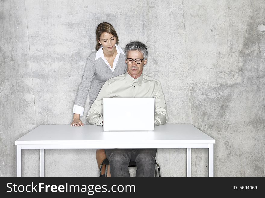 Men and women looking into a laptop, Teamwork. Men and women looking into a laptop, Teamwork