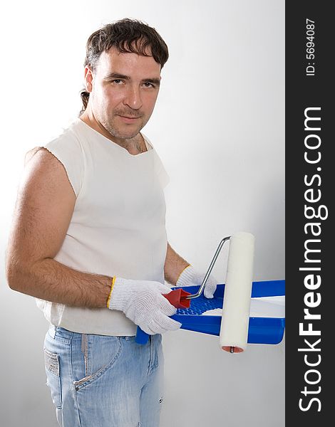 Cheerful worker preparing to painting a wall