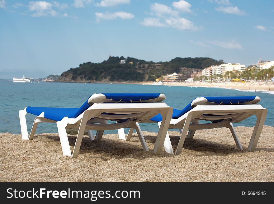 A photo of two chairs on the beach