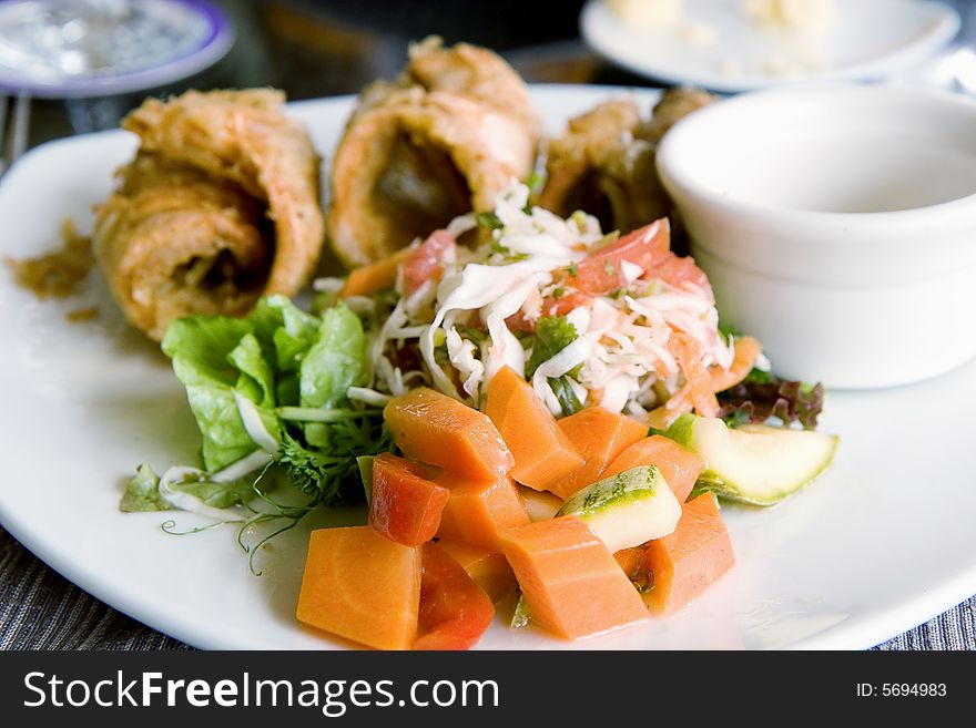 A fresh colorful dinner of vegetables, salad, and fried calamari. A fresh colorful dinner of vegetables, salad, and fried calamari