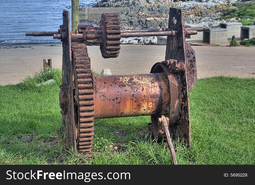 Ancient rusty boat winch at a small fishing harbour