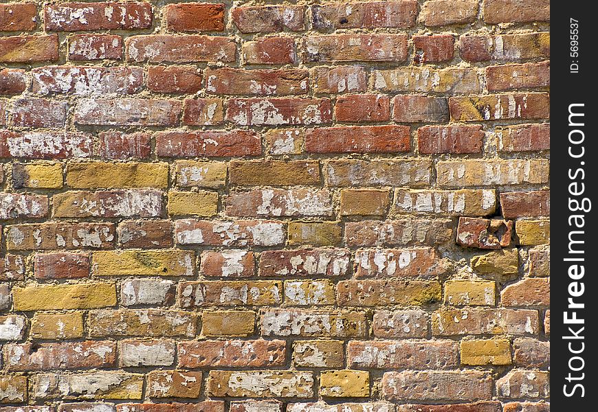 A wall made of old cracked bricks. A wall made of old cracked bricks