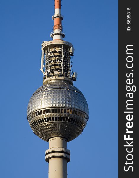 Close-up of the main section of the Television Tower in Berlin, against blue sky