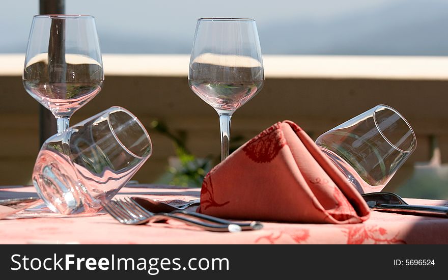 Restaurant table towels and glasses on sunny terrace french riviera. Restaurant table towels and glasses on sunny terrace french riviera