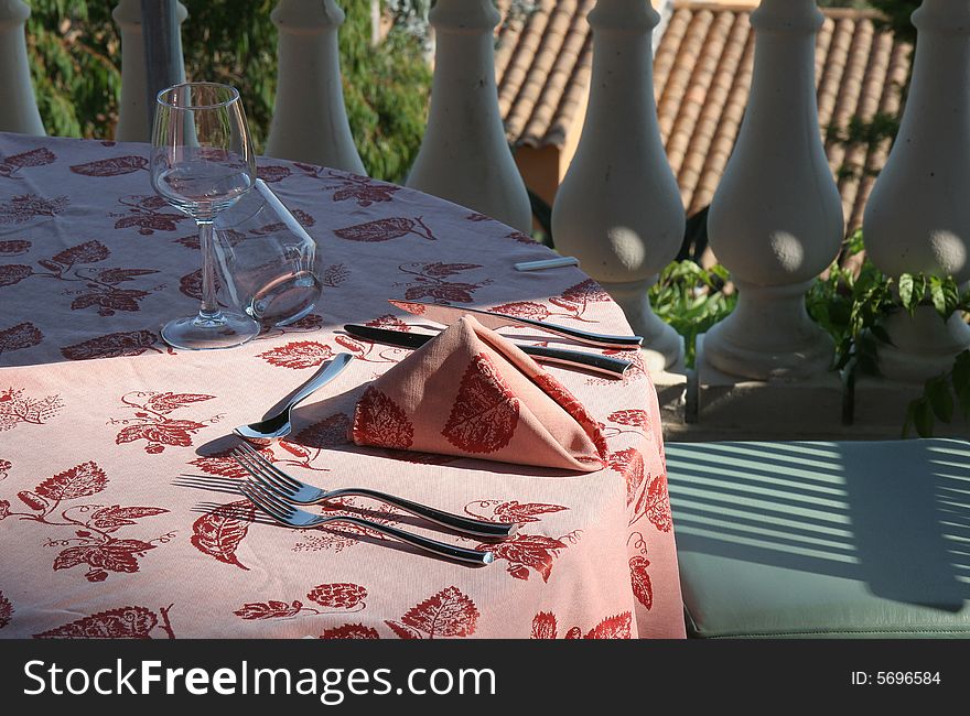 Restaurant table towels and glasses on sunny terrace french riviera balcony and parasols. Restaurant table towels and glasses on sunny terrace french riviera balcony and parasols