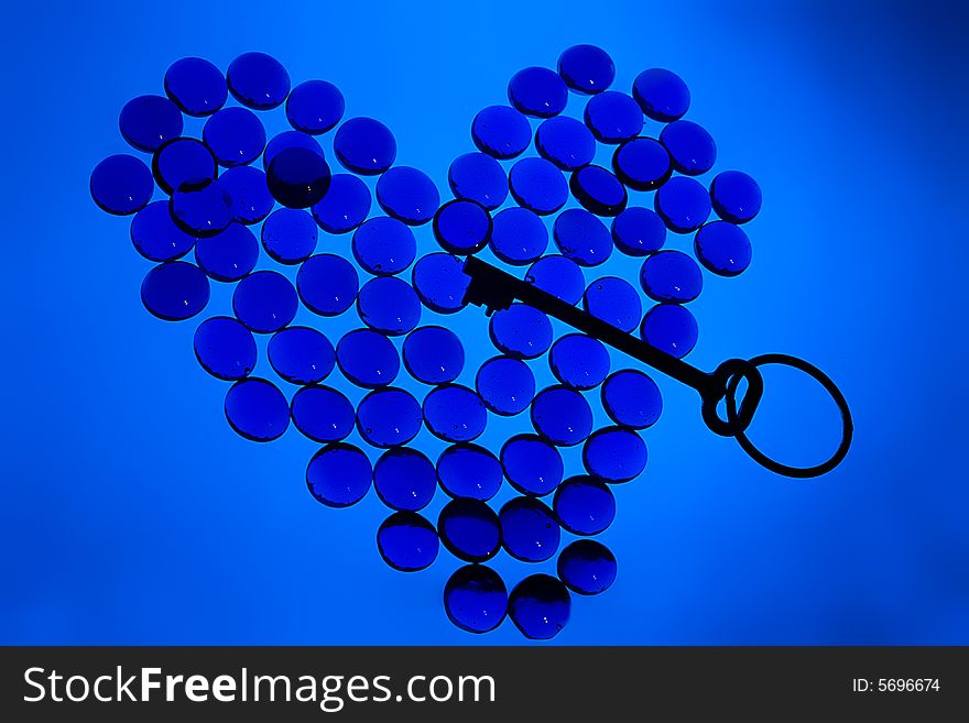 Heart Shape From Glass Pebbles With Key Inside