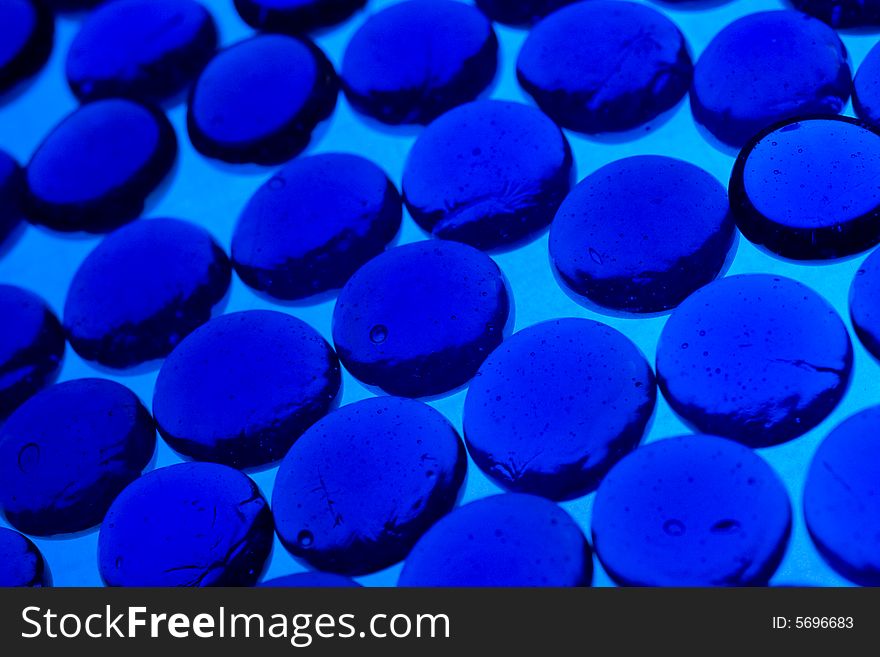 Abstract background from blue glass pebbles