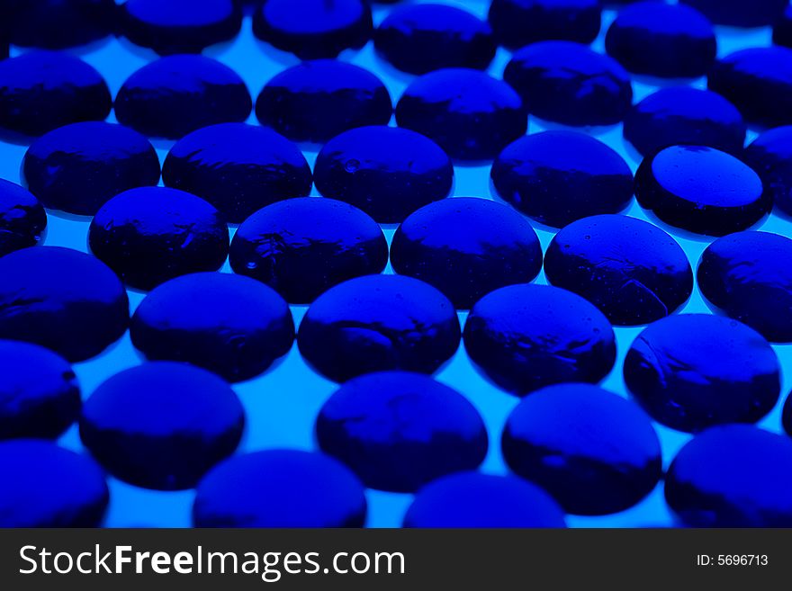 Abstract background from blue glass pebbles