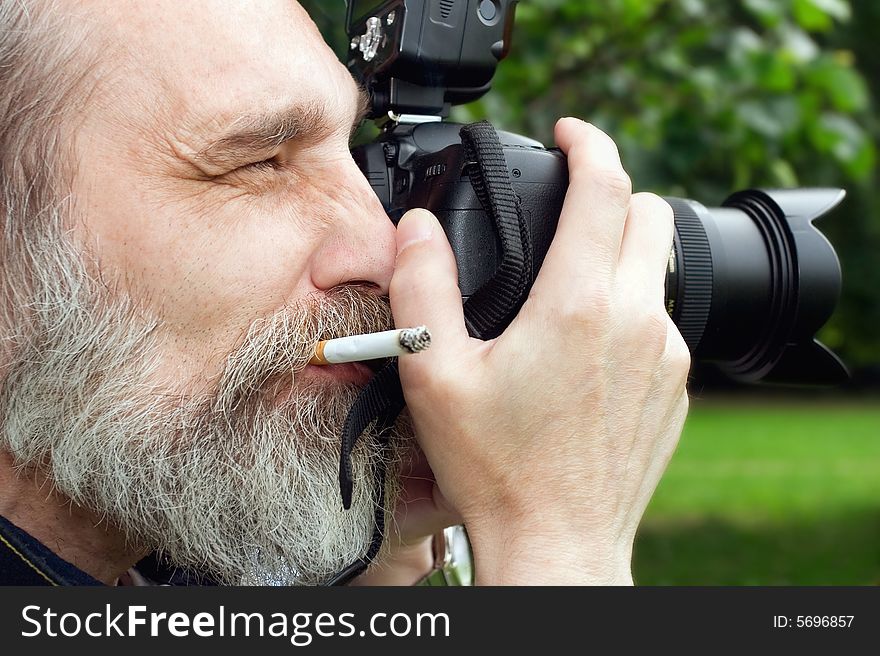 Photographer taking a shoot with a digital camera. Photographer taking a shoot with a digital camera