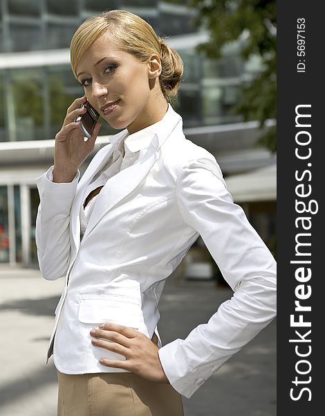 Attractive and confident businesswoman talking on the phone. Attractive and confident businesswoman talking on the phone