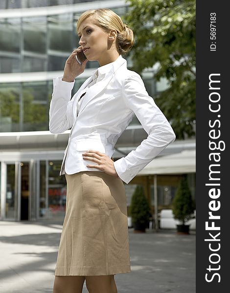 Attractive and confident businesswoman talking on the phone. Attractive and confident businesswoman talking on the phone