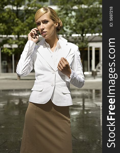 Attractive and confident businesswoman talking on the phone. Attractive and confident businesswoman talking on the phone