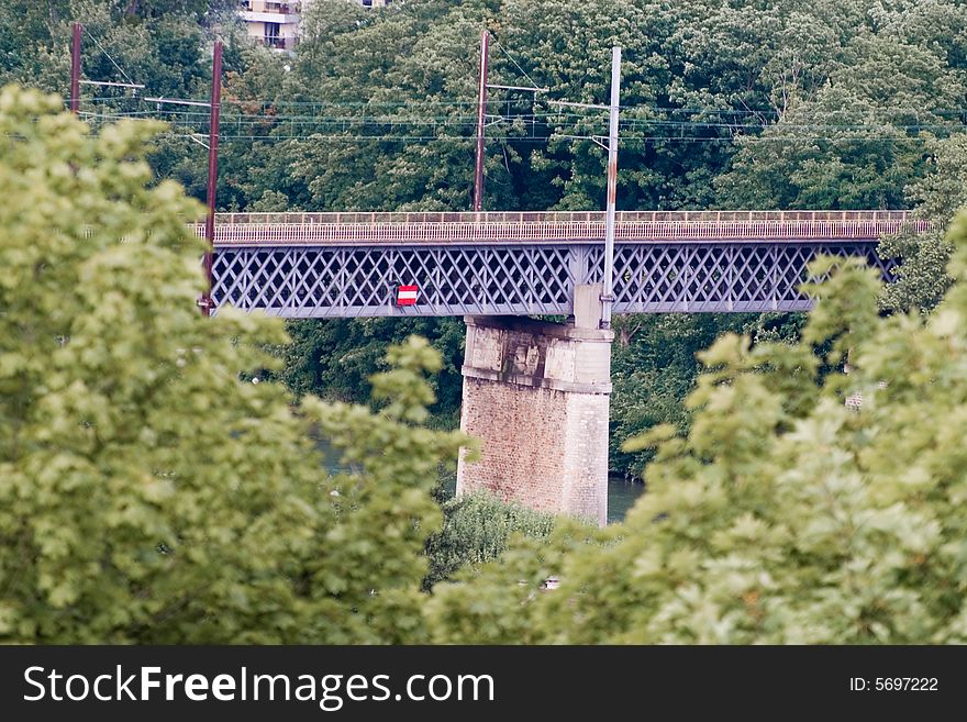 Photo of a railway bridge behind trees