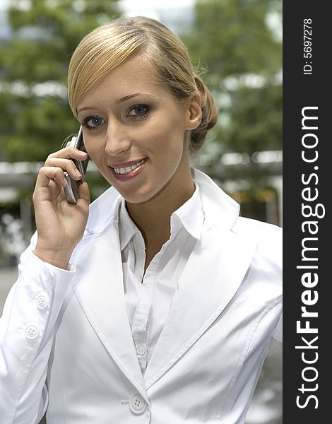 Attractive and confident businesswoman talking on the phone. Attractive and confident businesswoman talking on the phone