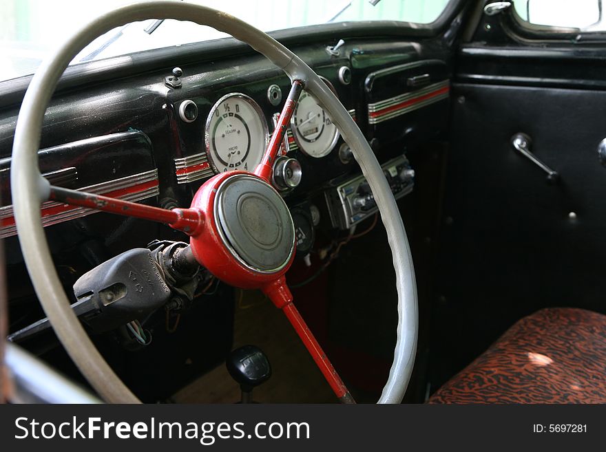 Vintage car interior. Steering wheel and dashboard