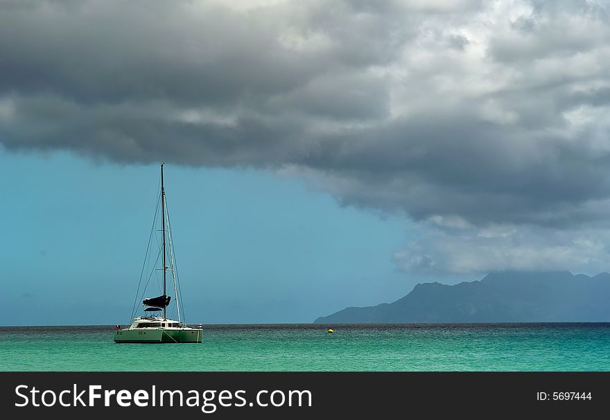 Catamaran boat is on the tropical sea . An island is on horizon.
The sea , sky and clouds as background. Catamaran boat is on the tropical sea . An island is on horizon.
The sea , sky and clouds as background.