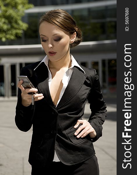 Young and attractive businesswoman talking on the mobile outside. Young and attractive businesswoman talking on the mobile outside