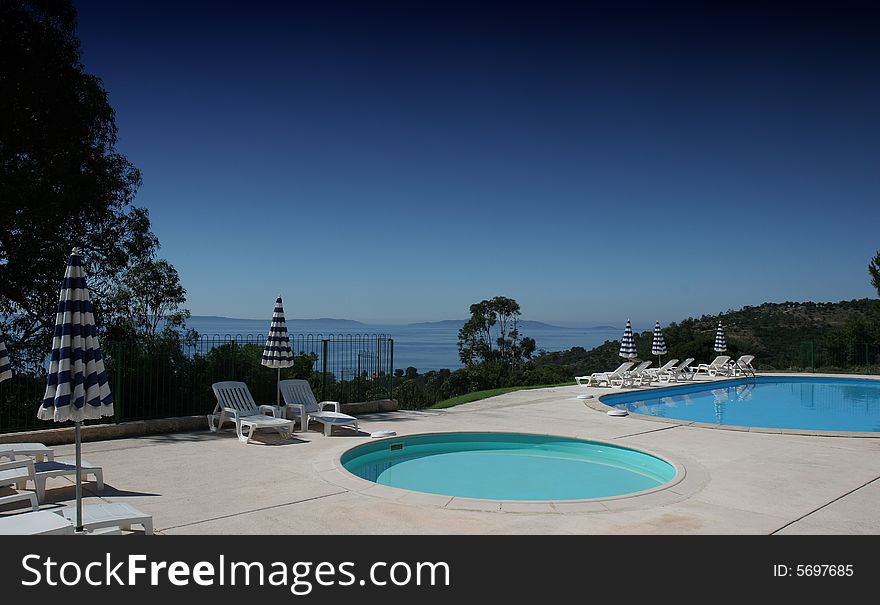 Poolside on the sea at le lavandou azur hotel  french riviera, france, with two pools. Poolside on the sea at le lavandou azur hotel  french riviera, france, with two pools