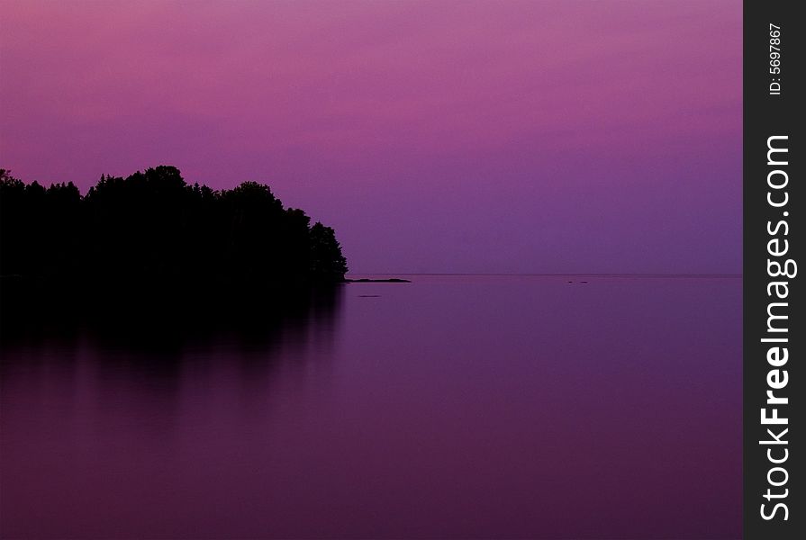 Flood Bay on the North Shore of Lake Superior in a magenta sunset. Flood Bay on the North Shore of Lake Superior in a magenta sunset