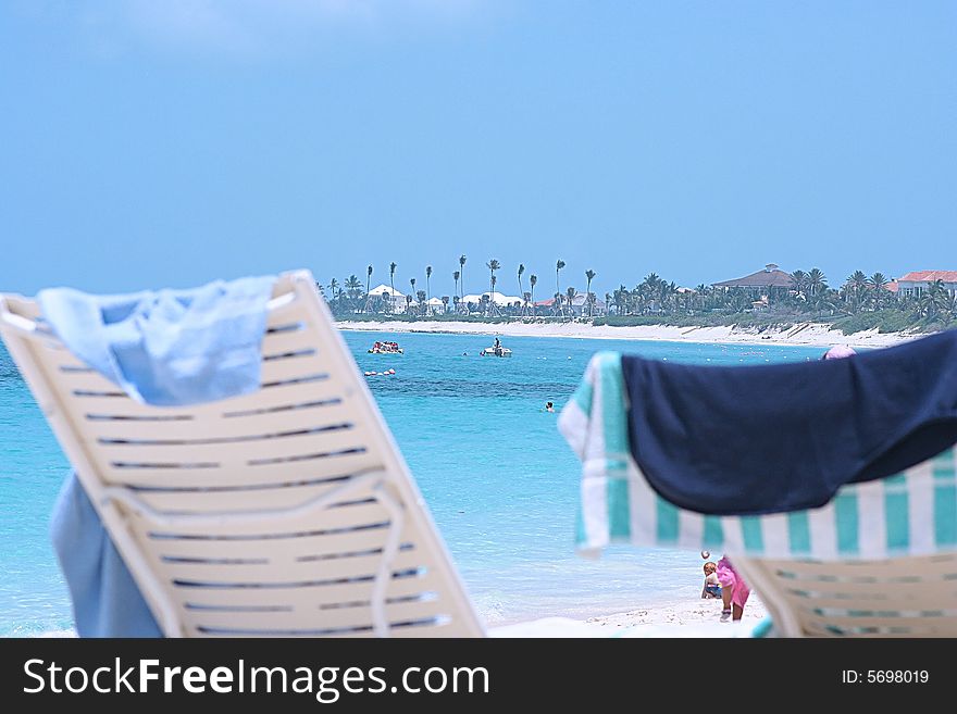 Two sun chairs on a beach looking at the ocean. Two sun chairs on a beach looking at the ocean...