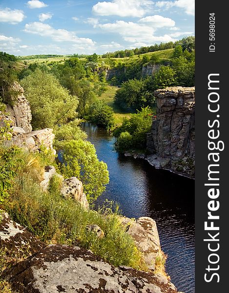 A gorgeous canyon with river, rocks and clouds